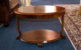 Art Deco Coffee Table of typical form with oval top and complimentary oval stretcher and stylised