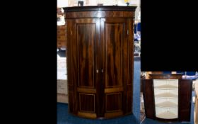 A Georgian Mahogany Cabinet Bow fronted wall mounted corner cabinet.