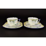 A Pair Of Shelley Art Deco Queen Anne Trios Two in total each comprising charger, saucer and cup,