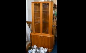 A 1970's Teak Display Cabinet By Turnbridge Corner cabinet with glazed top doors, piano hinges,