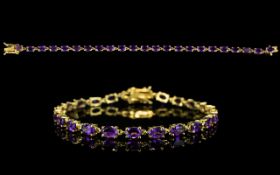 Amethyst Tennis Bracelet, a line of rich purple oval cut amethysts, totalling 9cts,