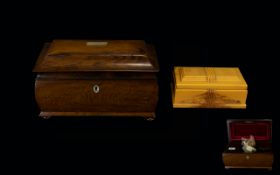 A Regency Rosewood Tea Caddy Hinged sarcophagus top with convex body on pad feet,