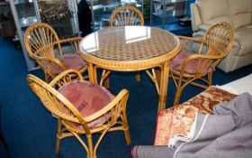 A Woven Cane Conservatory Table And Chairs Large circular table in golden cane with bevelled glass