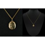 9ct Gold Back and Front Small Oval Shaped Locket with Attached 9ct Gold Chain. Marked 9ct.