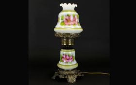 A Decorative Brass and Ceramic Oil Lamp, Raised on ornate brass footed base with central, floral