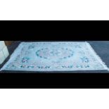 A Large Oriental Rug. With cream cotton fringe and floral lozenge to centre with floral and