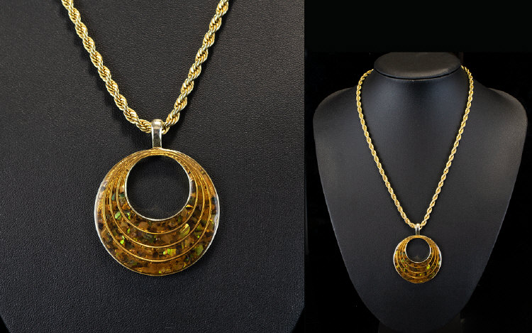 A Necklace on a Gold Coloured Chain In a