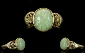 14 Carat Gold Single Stone Cabouchon Cut Jade Ring with Chinese design open worked shoulders,