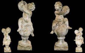 A Pair Of Well Weathered Reconstituted Stone Putti Figures Each depicted sat on sphere and socle