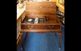 A Dynaton Golding G101 Gramophone/Record Player and Radio. Housed in walnut veneer floor standing