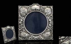 A Nice Quality Silver Photo Frame, Decorated with Embossed Images of Stylished Flowers and Cherubs,