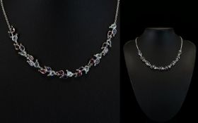 An 18ct White Gold Collarette Necklace Set With Swiss Blue Topaz Rhodolite And Iolite Wonderful