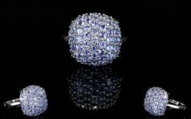 Tanzanite Cluster Ring, a square cushion of closely set, round cut tanzanites, the single source