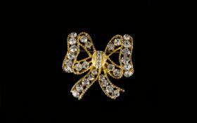 A Vintage Crystal Set Brooch By Eisenberg Gold tone brooch in the form of a bow, the whole set