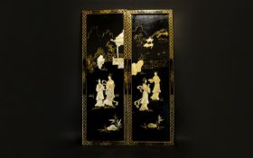 A Pair Of Oriental Panels Rectangular wood panels finished in black lacquer and gilt trim. Each