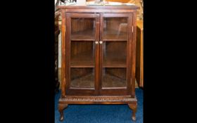A Glazed Display Cabinet raised on Queen Anne legs with glazed front doors and sides. With
