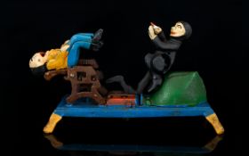 A Cast Iron Moneybank Painted bank in the form of an articulated dentists chair with figures