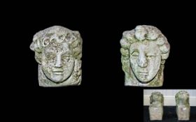 A Pair Of Reconstituted Stone Figures In the form of renaissance style child's head with square