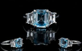 Sky Blue Topaz and White Topaz Ring, an octagon cut sky blue topaz set between two trapeze cut white