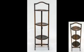 An Early 20th Century Three Tier Folding Cake Stand Oak stand with aged patina, height, 35 inches.