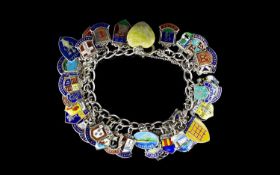 A Vintage Silver Curb Bracelet Loaded with enamel on silver shield medallions of town crests, over