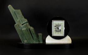 Art Deco Marble And Mixed Metal Mantle Clock Raised on oval black marble base, the clock of