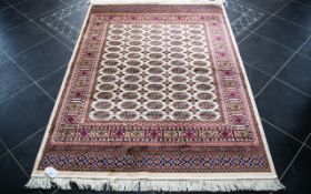 A Large Woven Silk Bokhara Carpet Ornate silk carpet with traditional lozenge and geometric repeat