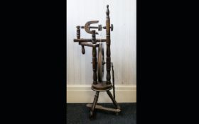 A Rustic Oak Spinning Wheel of traditional form, on tripod legs. Height 40 inches.