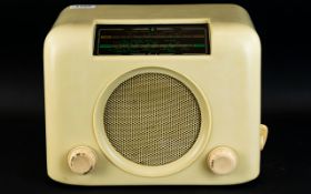 A Vintage Bush Radio Housed in square cream cellulose casing with display,