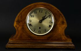 An Early 20th Century Mantle Clock In wood casing, of typical form with chevron inlay,