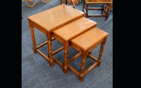 A Small Nest Of Tables Three low rectangular tables of plain form in varnished, aged oak.