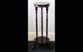 Mahogany Jardiniere Circular top and base, tripod legs barley twist pilasters. Height 34 inches.