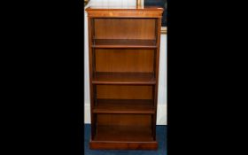 A Polished Veneer Three Shelf Bookcase of plain rectangular form.