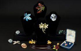 A Collection Of Floral Themed Costume Jewellery A varied collection to include enamel leaf brooch