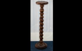 A Large Rustic Oak Jardiniere Stand circular top and base, turned barley twist pilaster.