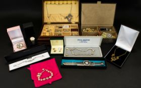A Quantity Of Costume Jewellery To include two jewellery boxes comprising earrings, brooches,