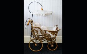 A Reproduction 19th Century Childs Pram. Metal frame with cane work body and wooden wheels.