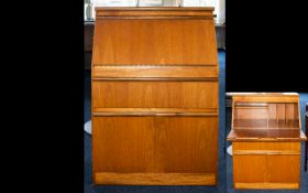 A British Mid Century Teak Bureau Correspondence desk of small proportions with hinged pull down