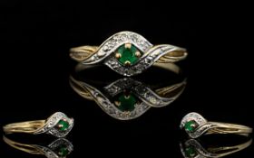 Ladies 9ct Gold Emerald and Diamond Dress Ring, The Central Emerald Surrounded by Diamond Chips.