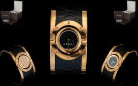 Gucci Twirl Rose Gold And Monogrammed Leather Ladies Watch YA 112438 Comprises wide black