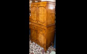 A Walnut Cocktail Cabinet of typical form, two doors, mirrored back, glass shelves.