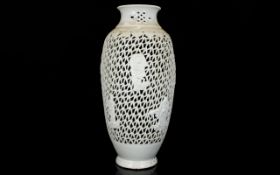 A Reticulated Oriental Lampstand Cream ceramic glazed ovoid lampstand with figural raised
