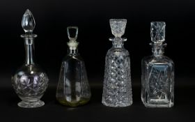 A Collection of Four Cut Glass Decanters to include footed specimen flask,