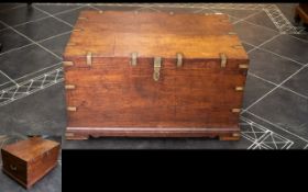 An Indonesian Hardwood Chest Comprising hinged top with brass handles and strap work.