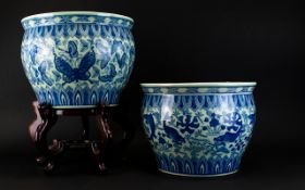 A Pair Of Blue And White Fish Bowls/Jardiniere. One Raised On A Wooden Stand.