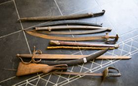 A Mixed Lot Of Modern And Antique Swords Scabbards And Knives All in poor condition,