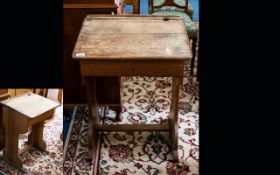 A Mid Century Pitch Pine School Desk Of typical form, in distressed condition.