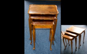 A Set of Three Walnut Nest of Tables shaped rectangular top with molded edge and raised on cabriole