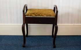 An Early 20th Century Piano Stool of plain form, hinged lid,