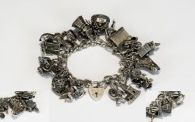 A Mid 20th Century Good Quality Silver Charm Bracelet - Loaded with Over 25 Quality Silver Charms.